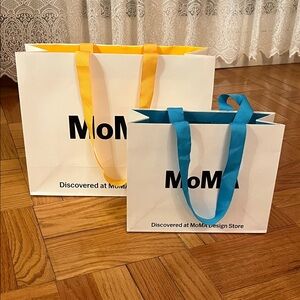 MoMA Tote Bags with Vibrant Yellow and Blue Handles